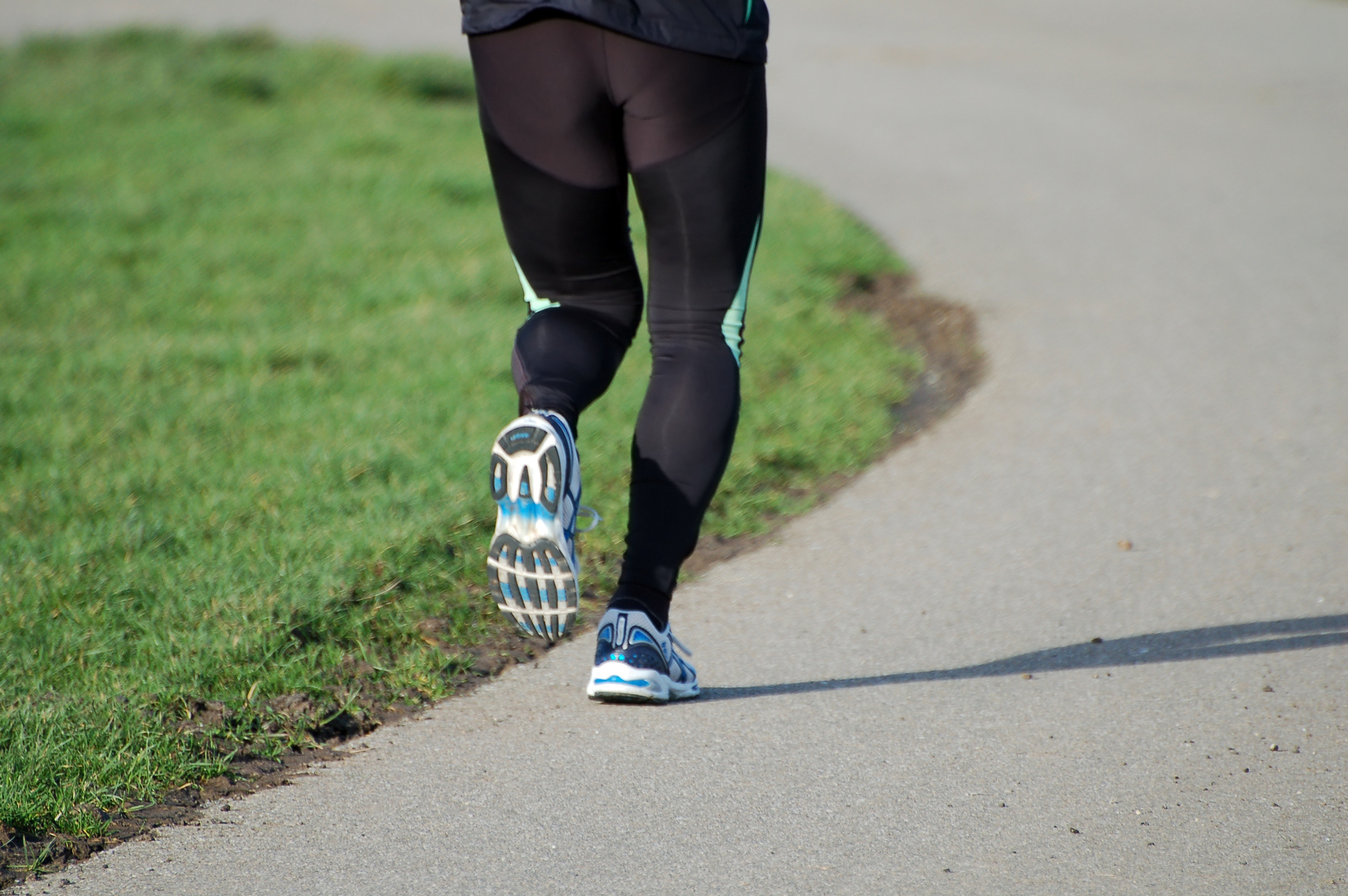 A man's legs shown jogging