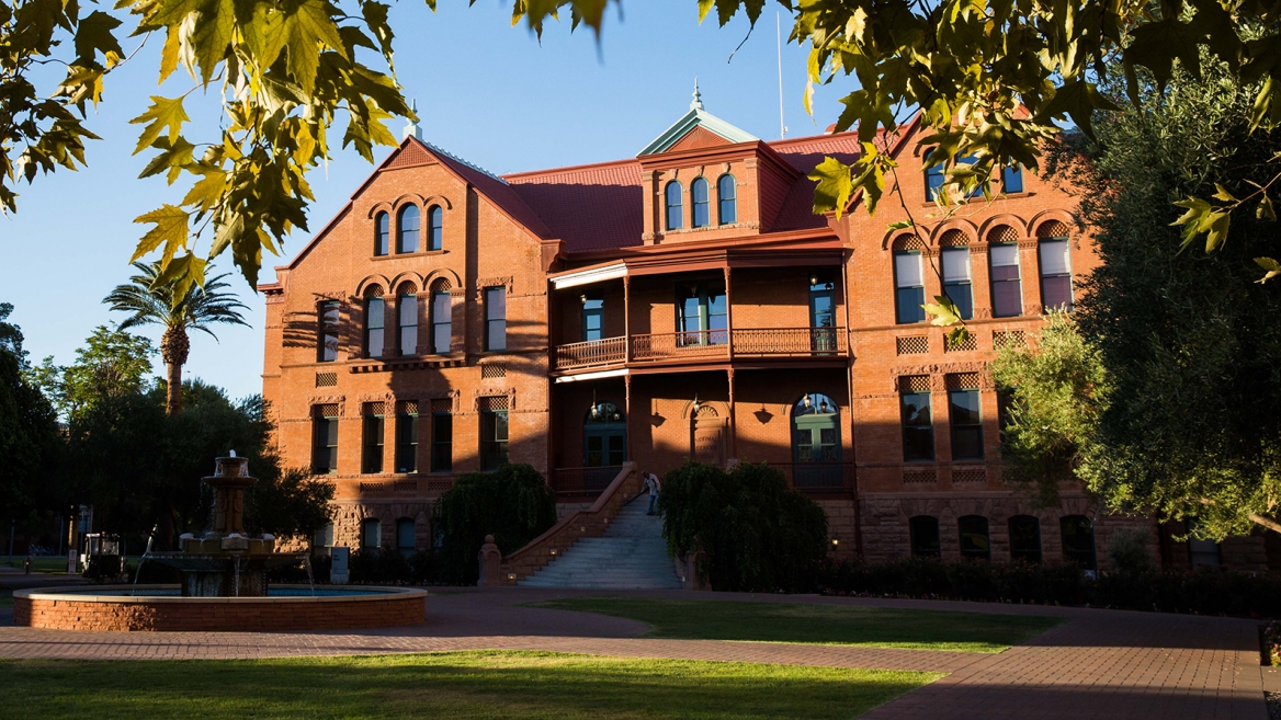 Exterior of a large, red brick building known as Old Main on ASU's Tempe campus.
